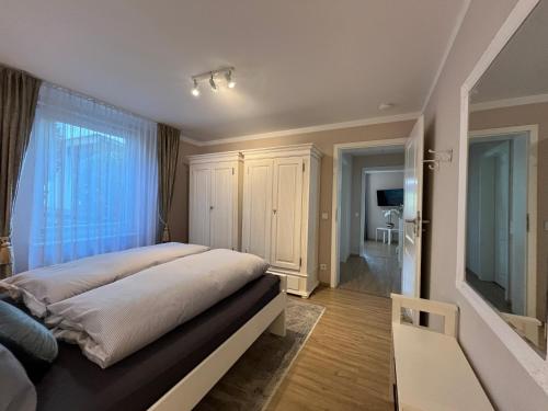 a bedroom with a large bed and a window at Schöne Wohnung im Landhausstil nahe Olpe Biggesee in Olpe