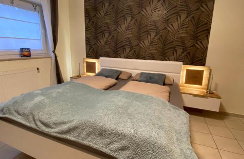 a bedroom with two beds and a large window at Ferienwohnung zwischen Wald und Reben in Göllheim