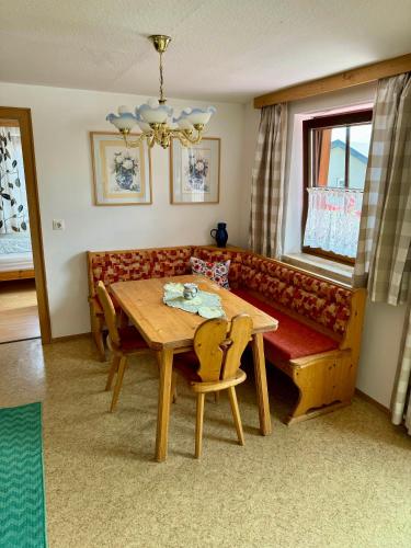 a living room with a wooden table and a couch at Blusnerhof in Virgen