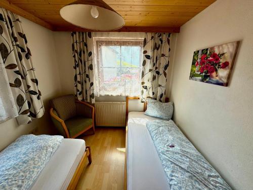 a small room with two beds and a window at Blusnerhof in Virgen