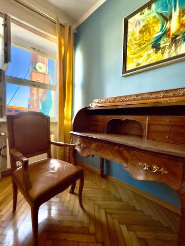 a piano in a room with a chair and a painting at Wroclaw Inn Apartments in Wrocław