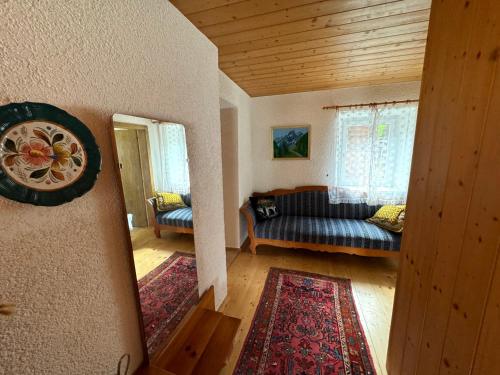 a living room with a couch and a window at Blusnerhof in Virgen