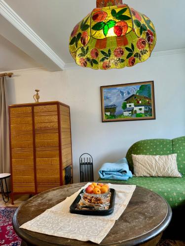 a room with a table with a plate of fruit on it at Blusnerhof in Virgen