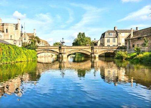 a bridge over a river in a city at Stylish Open Plan Guest House 400sq ft Rutland in South Witham