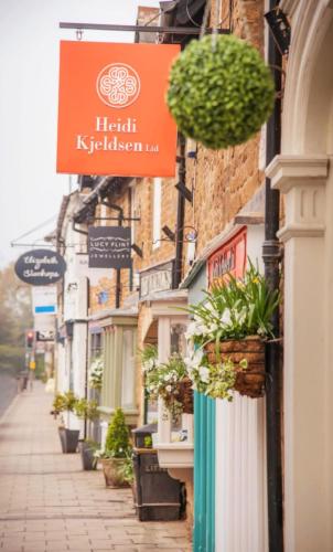 a street with potted plants on the side of a building at Stylish Open Plan Guest House 400sq ft Rutland in South Witham