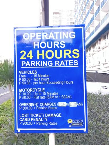 a sign that says operating hours hours parking rates at LIAM's Staycation in Manila