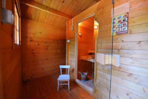 a sauna with a blue chair in a wooden room at Villa Steffani in Labin