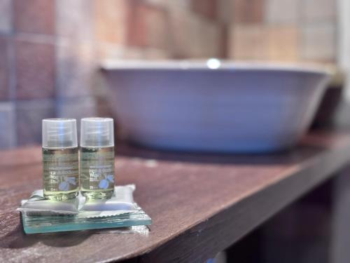 two empty glasses sitting on a wooden table at Hammam Rooms, Senorbì, Sardegna in Senorbì