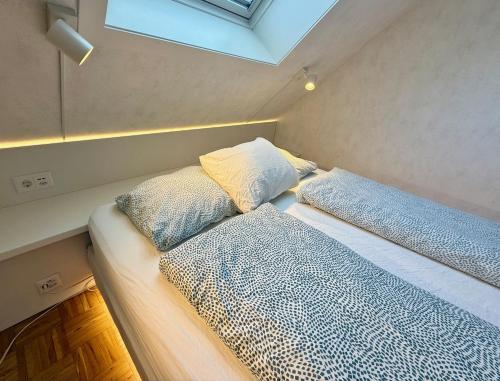 two beds in a small room with a window at bedinBERN Aparthotel in Bern