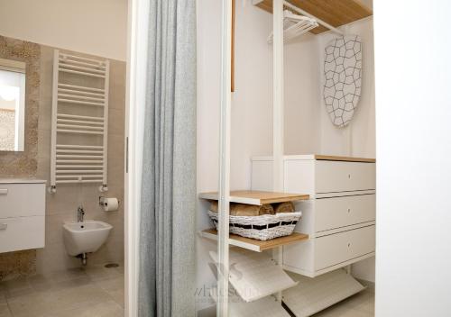 a bathroom with white cabinets and a sink at WHITE SOFIA - uno sguardo sul mare in Bari