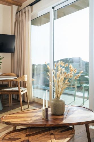 a living room with a table and a large window at Raviewha Luxury Apartments 2 in Ravdhoúkha
