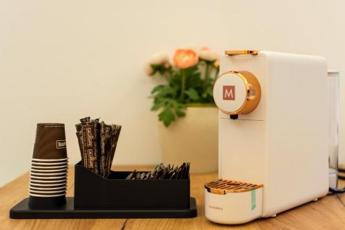 a clock sitting on a table next to a printer at Urban Beach Sirena in Francavilla al Mare