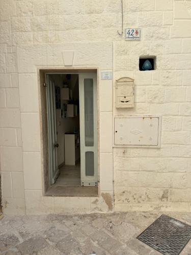 an entrance to a building with a door open at Casetta Azzurra in Monopoli