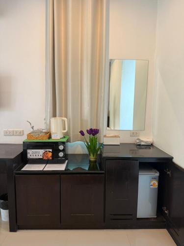 a kitchen with a counter with a sink and a mirror at Green Haven Villas With Jacuzzi in Krabi town