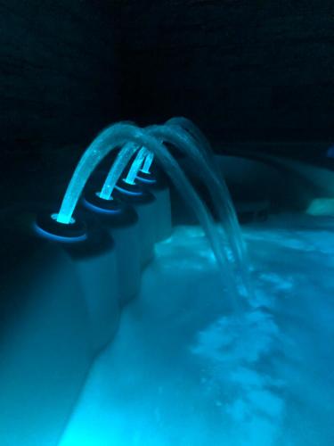 a close up of a swimming pool with blue water at Zengő Kincse SPA Vendégház Hosszúhetény in Hosszúhétény