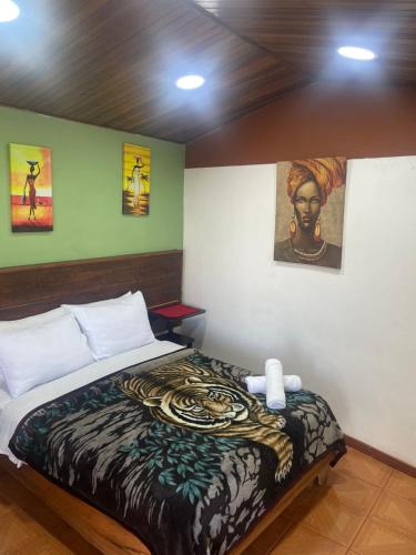 a bedroom with a bed with a snake blanket at Cabinas Vista Al Golfo in Monteverde Costa Rica