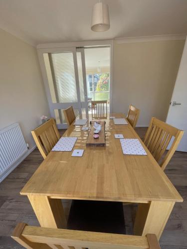 a wooden table with four chairs and a wooden tableablish at 20 Fairview Chepstow in Chepstow