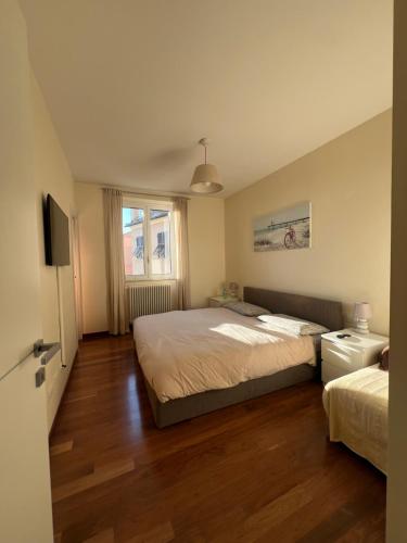 a bedroom with two beds and a television in it at La casa di Eli in Genoa