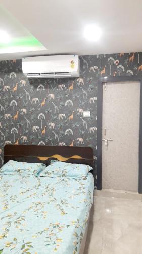 a bedroom with a bed and a wall with birds at Vizag Venya Vihar a 2BHK Deluxe Furnished HomeStays in Visakhapatnam