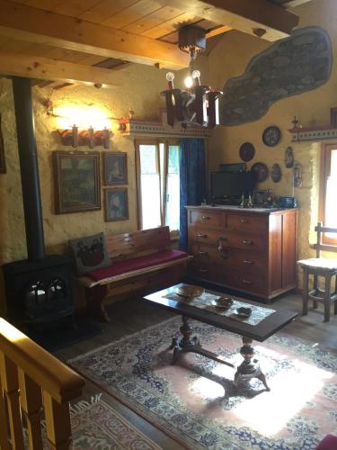 a living room with a couch and a table at La Casetta sulla Marteniga in Trichiana