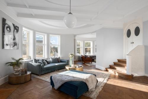 a living room with a couch and a table at Small castle from 1915 in Kalvøya