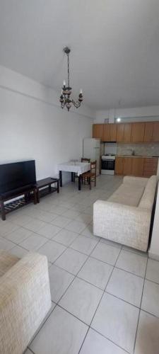 a living room with two couches and a table at Areopoli Apartment 7 in Areopolis