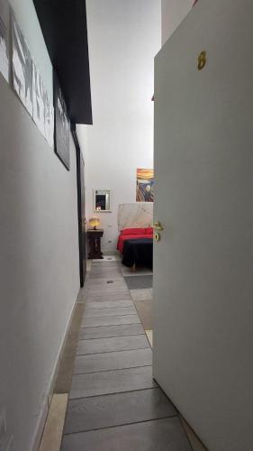 a hallway with a room with a bed and a door at B&B Cappotto civico 48 in Pompei