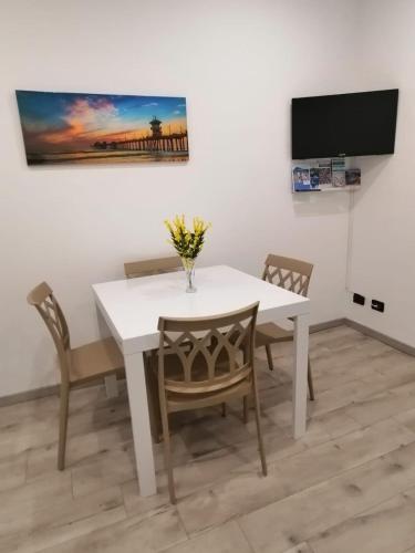 a dining room with a white table and chairs at 2 Mimose in Recco