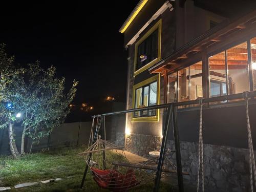 a house with a hammock outside of it at night at Ömer bey konak in Akcaabat