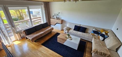 a living room with a couch and a coffee table at Artemida Nature and Peace in Radomlje