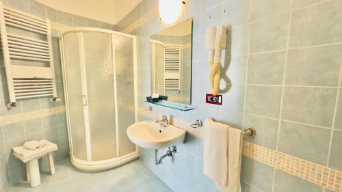 a bathroom with a sink and a shower at Residence & Suites in Bellaria-Igea Marina