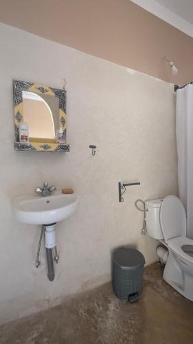 a bathroom with a sink and a toilet at Kasbah Desert Camp in Mhamid