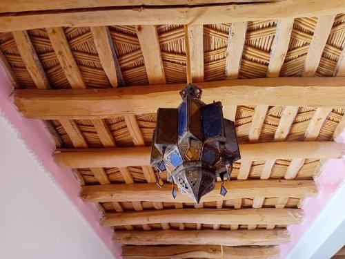 a chandelier hanging from a wooden ceiling at Hotel Source De Dades in Boumalne