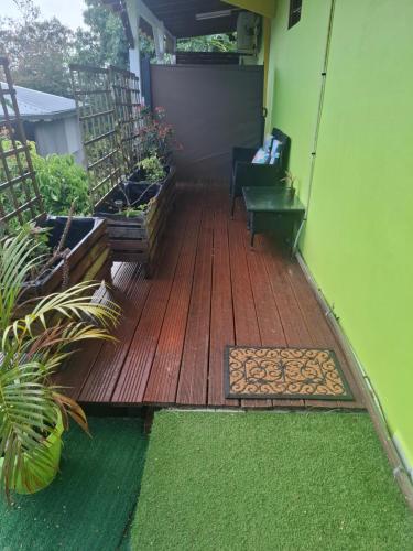 a wooden deck with a bench on a house at Chez nana in Pointe-Noire