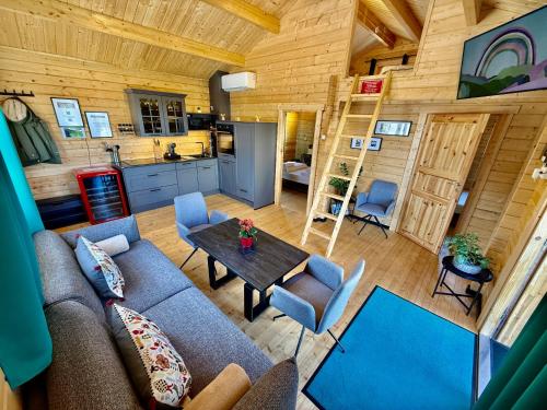 a living room with a couch and a table in a cabin at Chalet Lasserg in Münstermaifeld