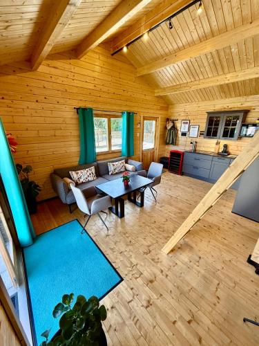 a living room with a couch and a table at Chalet Lasserg in Münstermaifeld