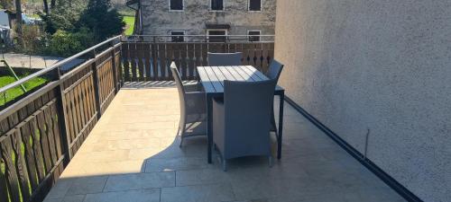 a patio with a table and chairs on a balcony at Bioledro - Casa Lena in Mezzolago