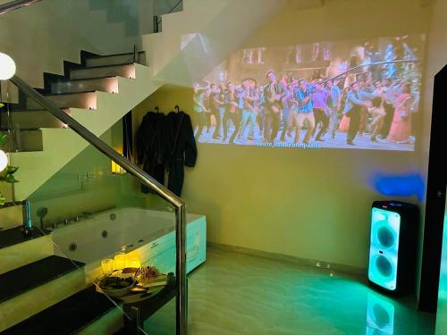 a room with a staircase and a painting on the wall at Katha Villa 63 - Luxury Holiday Home in Karjat