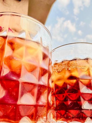 two glasses of iced tea sitting next to each other at Katha Villa 63 - Luxury Holiday Home in Karjat