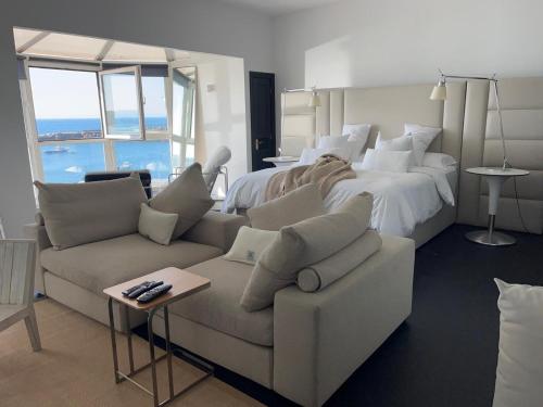a large bedroom with a large bed and a couch at Seaside in Portrush
