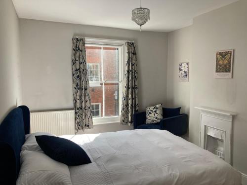 a bedroom with a bed and a window at Painters Cottage, Grade II Listed, Salisbury in Salisbury