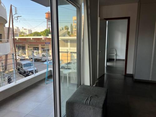 a room with a balcony with a view of a parking lot at Jedi Hub Hostel in Limassol
