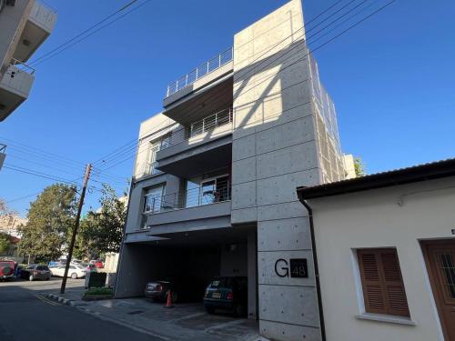 a building with a parking garage in front of it at Jedi Hub Hostel in Limassol