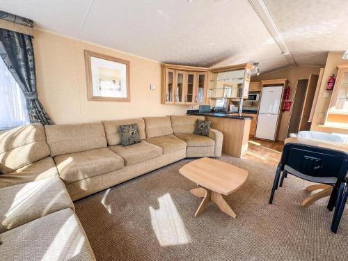 a living room with a couch and a table at 6 Berth Pet Friendly Caravan By Hunstanton Beach, Norfolk Ref 13012L in Hunstanton