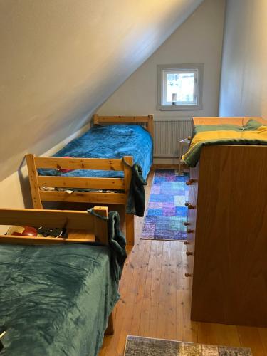a attic bedroom with two beds and a window at Large family home Storfamiljsboende in Mariannelund