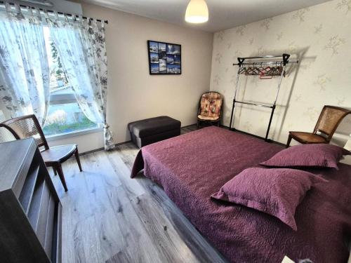 une chambre avec un lit, une chaise et une fenêtre dans l'établissement Résidence Le Clos Des Merisiers - Au coeur de la ville, bel appartement très fonctionnel ! MAE-2494, à Aix-les-Bains