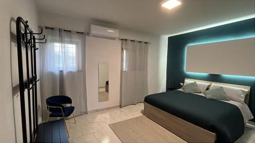 a bedroom with a bed and a blue wall at Maison Al Vecchio Cinema in Alife
