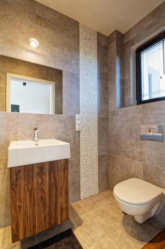 a bathroom with a sink and a toilet at Domki Dominika in Władysławowo