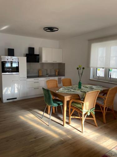 a kitchen and dining room with a table and chairs at Jack24 Wörnitzstrand in Harburg