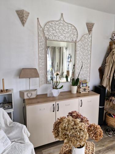 a bedroom with a mirror and a dresser at Mon havre de paix in Blésignac